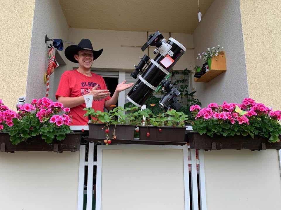Andreas neben einem großen Teleskop auf dem Balkon
